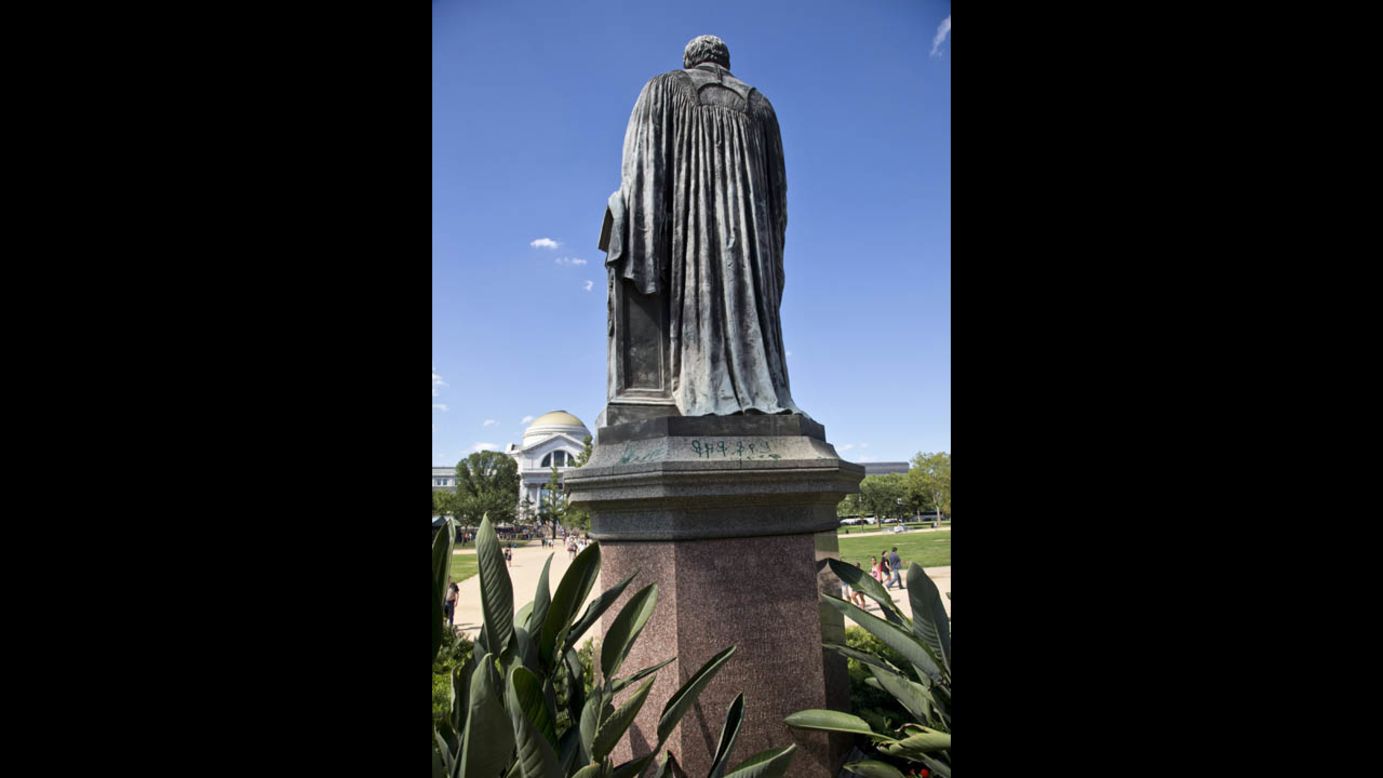 Green paint was tossed on the pedestal of the statue of Joseph Henry outside the headquarters of the Smithsonian Institution in Washington on Monday, July 29.
