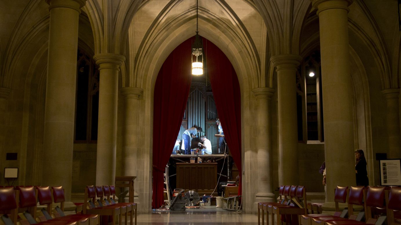 Members of Gold Leaf Studios, an art preservation organization, work to remove green paint from the organ in the Washington National Cathedral's historic Bethlehem Chapel on Tuesday, July 30.