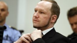 Self confessed mass murderer Anders Behring Breivik adjusts his tie in court room 250 at Oslo District Court on August 24, 2012. An Oslo court today found Anders Behring Breivik guilty of 'acts of terror' and sentenced him to 21 years in prison for his killing spree last year that left 77 people dead. AFP PHOTO / POOL / HEIKO JUNGE (Photo credit should read Junge, Heiko/AFP/GettyImages)