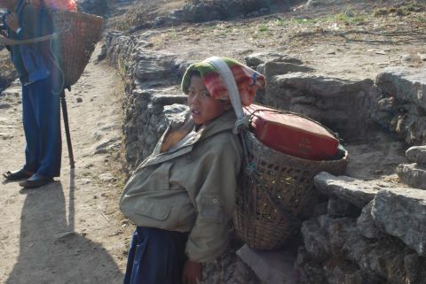 A weary child porter takes a break in Nepal's Solukhumbu district in 2010. According to statistics published by the UN Development Program, 44.2% of Nepal's population lives under the poverty line. To make ends meet, some parents send their children to work.