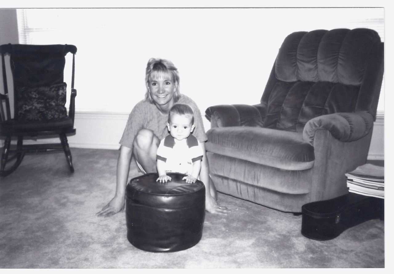 "The prize is here, now. In every breath you take, every new friend, every kiss, every challenge, every exciting piece of information you discover," Mitchell wrote to her son. Here, she poses with Nick when he was 6 months old. <br />