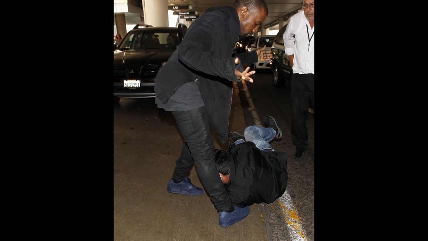 Kanye West clashes with paparazzi over questions about