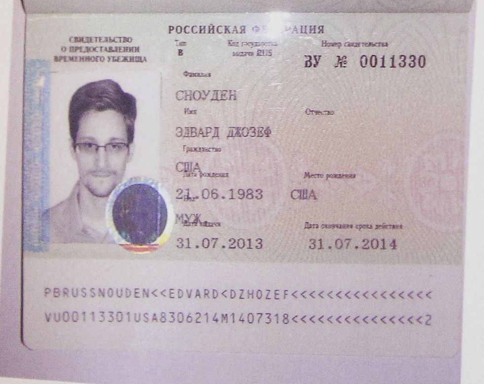 Snowden's refugee document granted by Russia is seen during a news conference in Moscow on August 1. Snowden slipped quietly out of the airport <a href="http://www.cnn.com/2013/08/01/us/nsa-snowden/index.html?hpt=hp_t2">after securing temporary asylum in Russia</a>, ending more than a month in limbo.