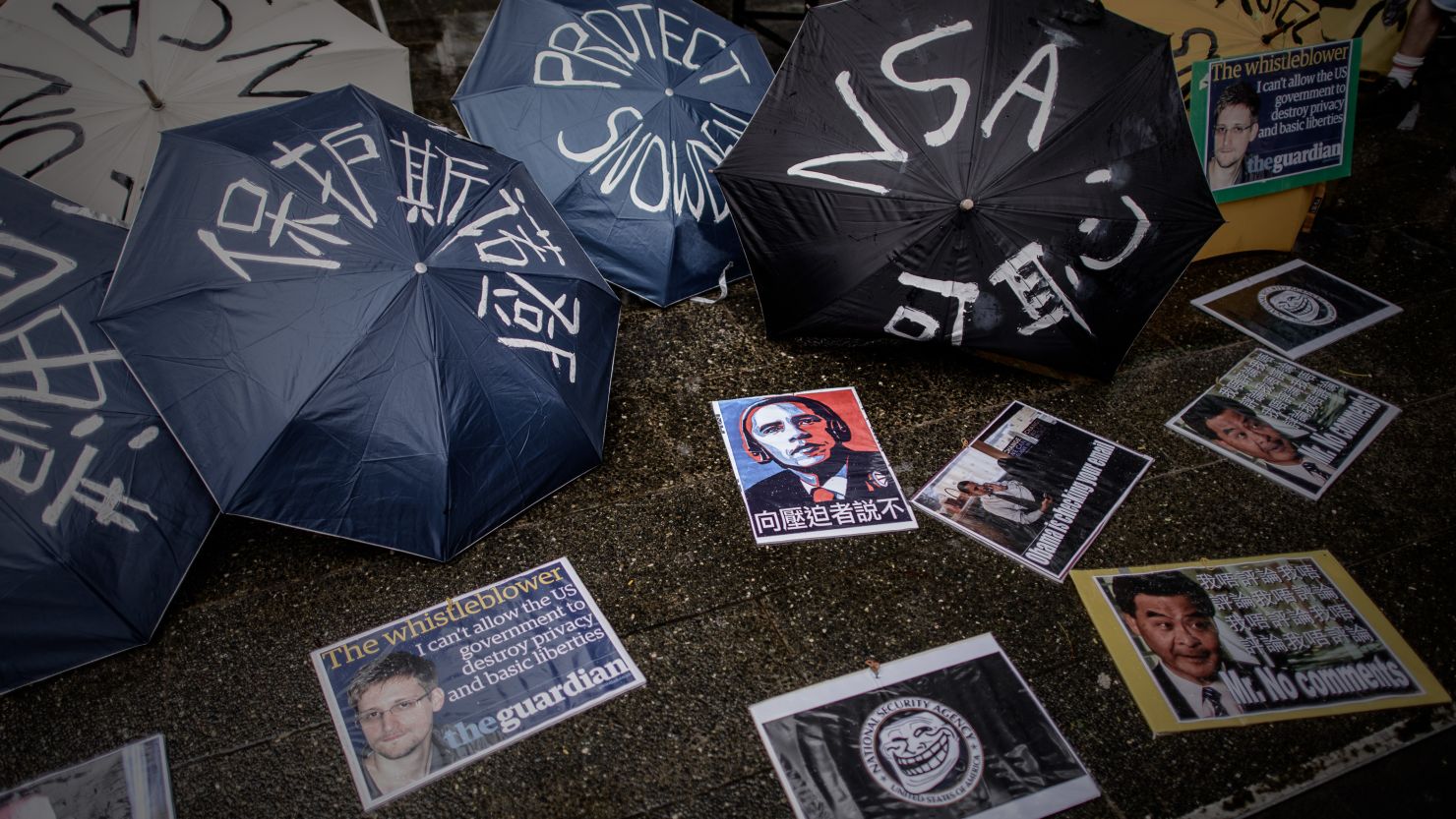 Umbrellas with slogans are lined up before a Hong Kong march to the US consulate in support of NSA leaker Edward Snowden.