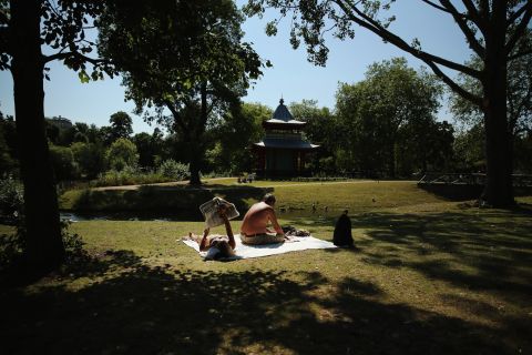 People relax in the sun in Victoria Park in London, on Thursday, August 1.