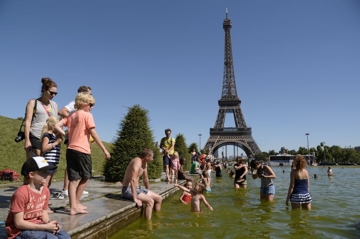 People sunbath on lawns near the Eiffel Tower in Paris, on August 1.