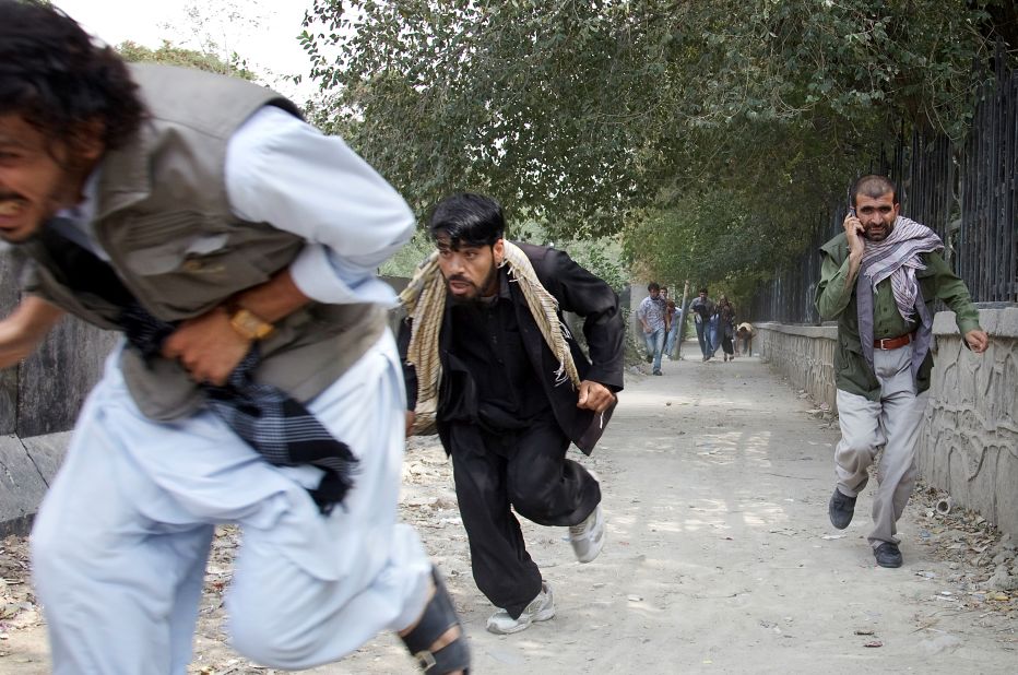 People flee the scene of a Taliban attack on the <a href="http://news.blogs.cnn.com/2011/09/13/u-s-embassy-in-afghanistan-attacked-taliban-claims-responsibility/">U.S. Embassy in Kabul, Afghanistan,</a> on September 13, 2011. Three police officers and one civilian were killed. There were no reports of U.S. casualties.