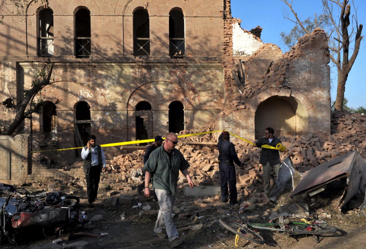Officials examine the aftermath of a terrorist attack outside the <a href="http://www.cnn.com/2010/WORLD/asiapcf/04/05/pakistan.blast/index.html">U.S. Consulate in Peshawar, Pakistan,</a> on April 5, 2010. The coordinated attack involved a vehicle suicide bomb and attackers who tried to enter the consulate by using grenades and weapons fire. Two consulate security guards and at least six others were killed.