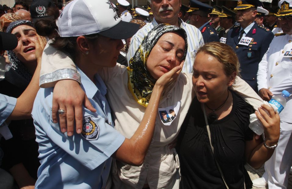 Relatives of slain police officers are comforted during a funeral in Istanbul, Turkey, on July 10, 2008, a day after the <a href="http://news.bbc.co.uk/2/hi/7497049.stm" target="_blank" target="_blank">U.S. Consulate there </a>was attacked. Three police officers and three attackers were killed in what the American ambassador to the country called "an obvious act of terrorism" aimed at the U.S.
