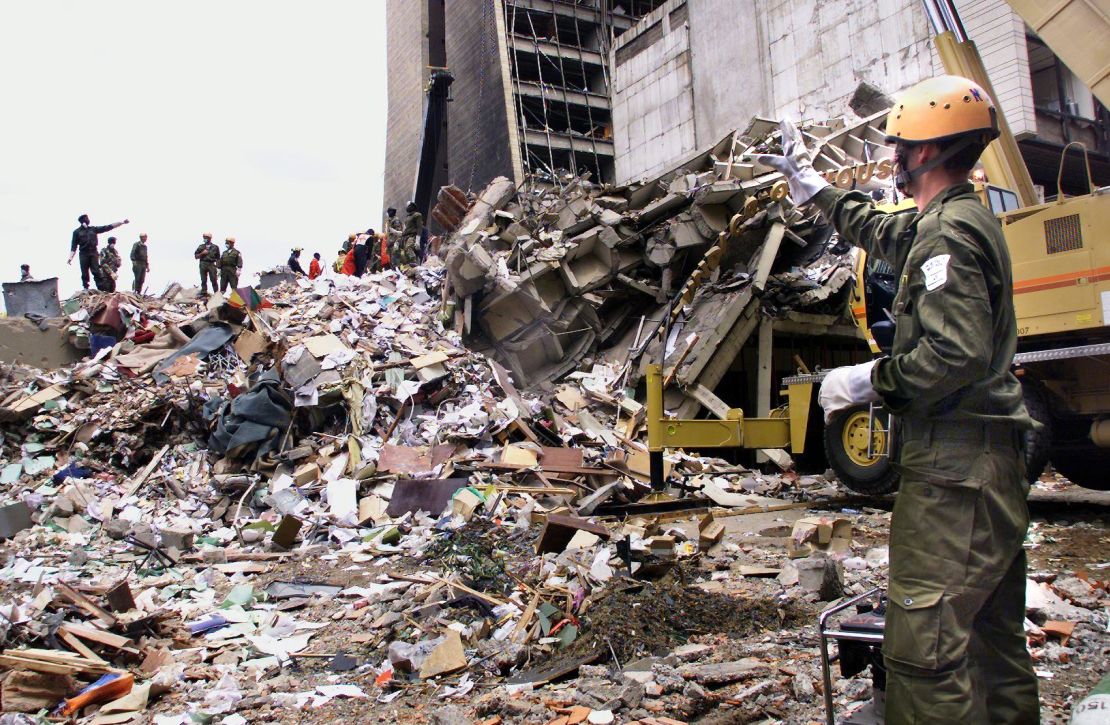 A rescue worker stands on the remains of what used to be the U.S. Embassy in Nairobi.