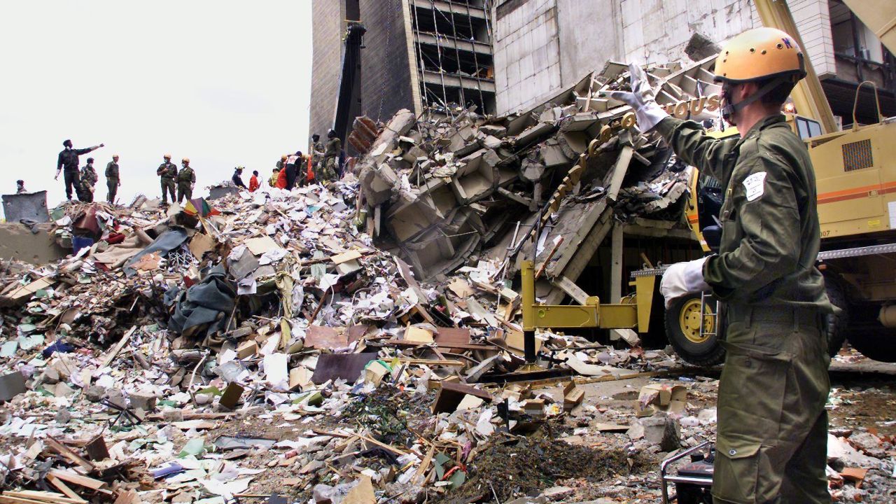 A rescue worker stands on the remains of what used to be the U.S. Embassy in Nairobi.