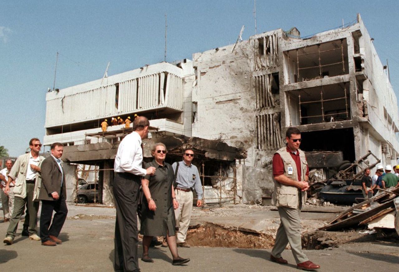 Secretary of State Madeleine Albright, center, walks past the damaged <a href="http://www.cnn.com/WORLD/africa/9808/08/africa.explosions.01/">U.S. Embassy in Dar es Salaam</a> on August 18, 1998. The August 7 attacks in Tanzania and Kenya were later attributed to al Qaeda.