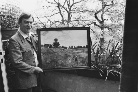 Patrick Troughton, who played the second Doctor from 1966-1969, holds one of his own paintings outside his home in Teddington, London, on May 5, 1981.