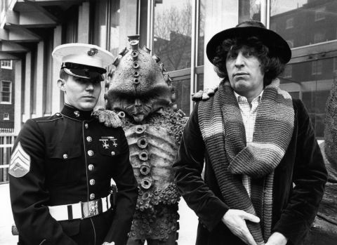 The fourth Doctor, played by Tom Baker from 1974-1981, standing alongside a Zygon, meets Sergeant Frank Ziegler, a guard at the American Embassy in Grosvenor Square, London in 1978.
