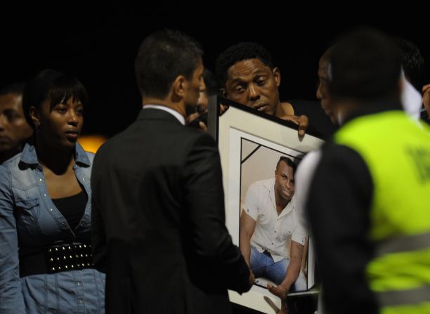 Grieving relatives of Ecuador football star Christian Benitez are at Mariscal Sucre Airport in Quito as his body arrives home.