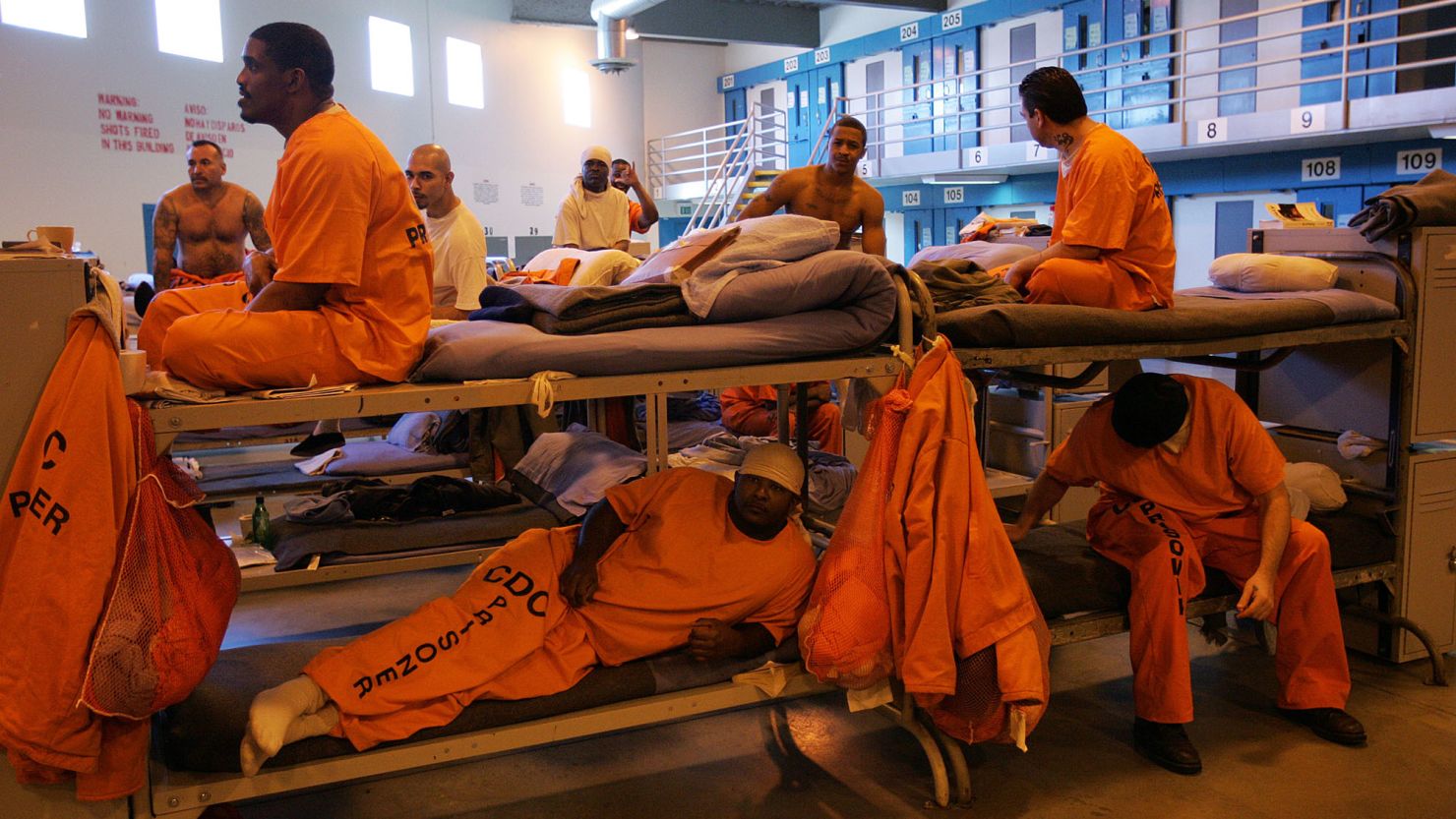 Inmates fill a converted dayroom, which is being used as temporary "emergency" sleeping area at California State Prison-Los Angeles County in Lancaster, California. 