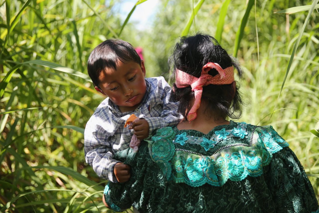 AUGUST 2 - TALISMAN, MEXICO: An indigenous family walks from Guatemala into Mexico after illegally crossing the country's southeastern border at the Suchiate River on August 1. An increasing number of Central Americans pass illegally into Mexico, many on the first leg of their long and perilous journey north towards the United States.