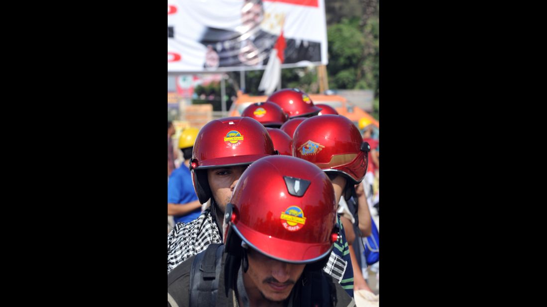 Morsy supporters in red helmets march during a protest against the government in Cairo on August 2. Pro-Morsy marches began after Friday prayers, when supporters made their way back to their camp outside the Rabaa al-Adawiya mosque. 