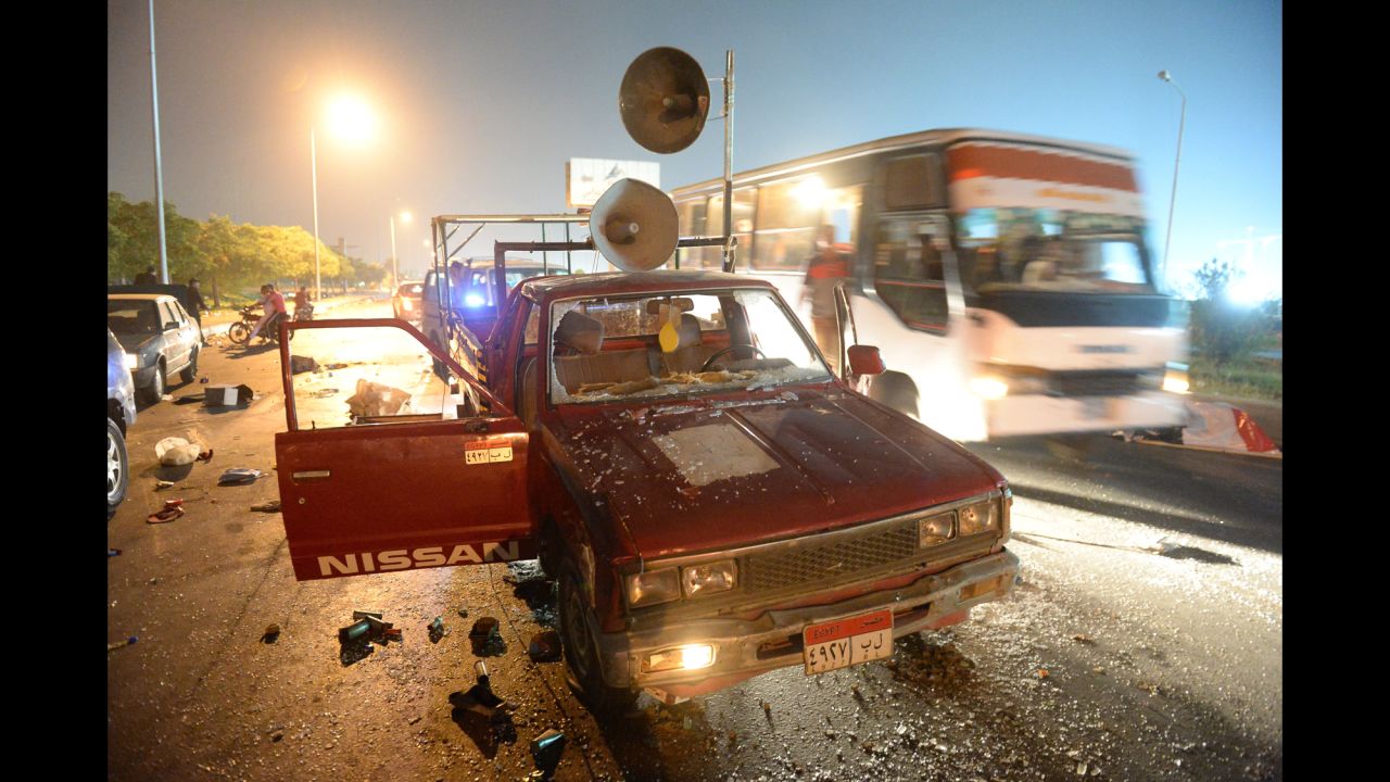 A bus passes a destroyed pickup truck with loudspeakers that was used by supporters of ousted Egyptian President Mohamed Morsy on Friday, August 2. The supporters and security forces clashed in Sixth of October City in Giza, south of Cairo, after the government ordered their protest camps be broken up. <a href="http://www.cnn.com/2013/08/15/middleeast/gallery/egypt-violence-august/index.html" target="_blank">Look at the latest violence in Egypt.</a>