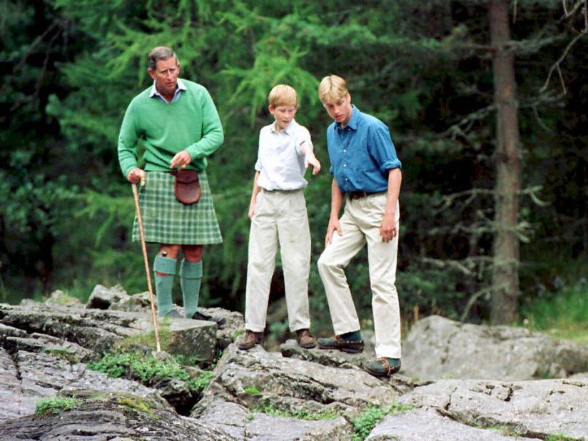 The Prince of Wales, left, and his sons Prince William, right, and Prince Harry stand above the Falls of Muick at Balmoral in 1997.