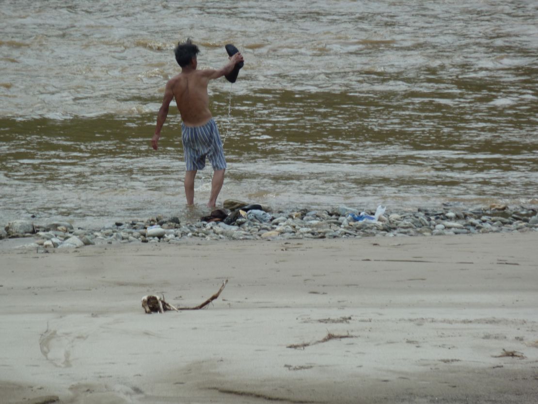 A North Korean man washes in a river in Hyangsan.