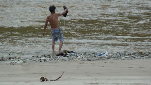 A North Korean man washes in a river in Hyangsan.