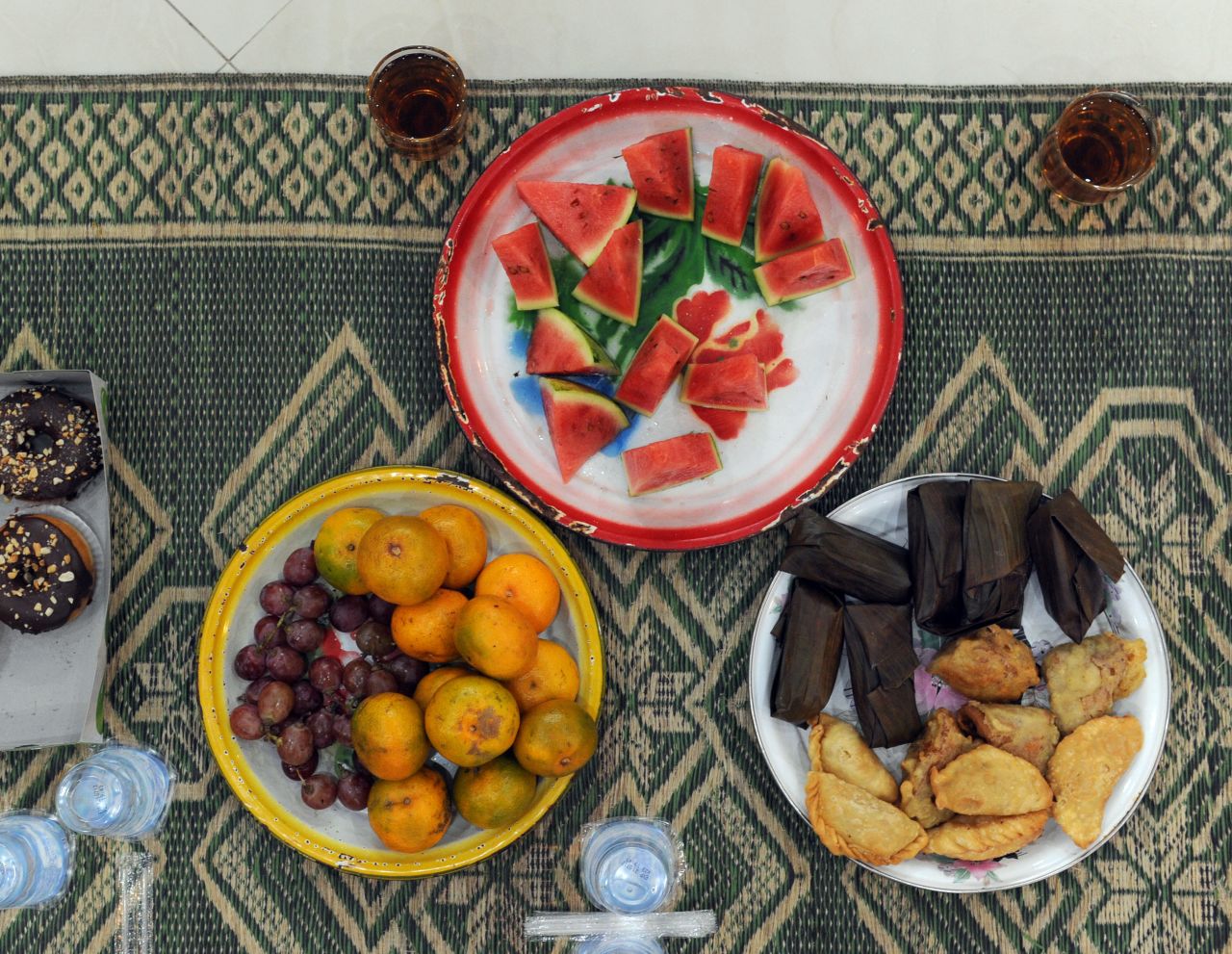These delicious goodies about to be served to children in a mosque in Jakarta, Indonesia, could be a typical Iftar plate -- the meal eaten to break the fast. It consists of an array of fruits, rice cakes, donuts, tea and water. 
