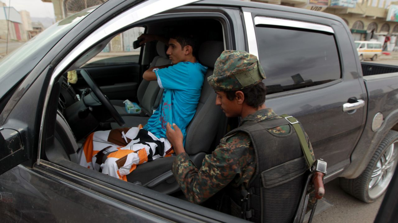 A Yemeni soldier searches a car at a checkpoint on a street leading to the US embassy compound in Sanaa on August 4, 2013. Security measures were particularly strict in the Yemeni capital after Washington held urgent talks on an Al-Qaeda threat that prompted two dozen embassies and consulates to temporarily halt their services in many capitals in the region. 