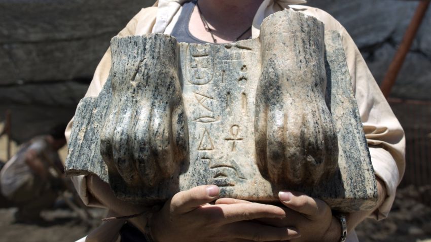 Australian excavation volunteer Joshua Talbot displays the remains of a Sphinx with a hieroglyphic inscription between its paws dating circa 3rd century BCE, found during excavation in the Northern Israeli archeological site of the ancient Tel Hazor, revealed on July 9 2013