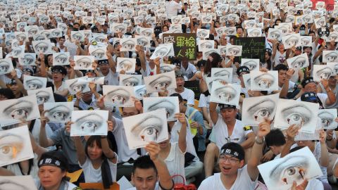 Protesters hold placards during an anti-military rally in front of Taiwan's presidential office in Taipei.