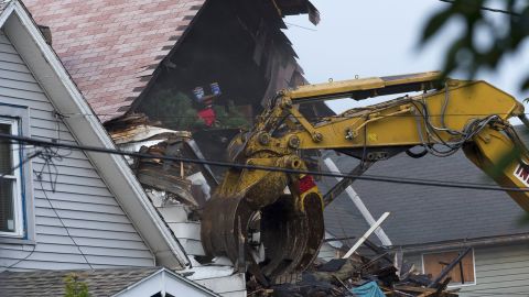 A crane demolishes the Cleveland house of Castro on August 7. Plans call for the house to be torn down and the lot cleared in a single day.