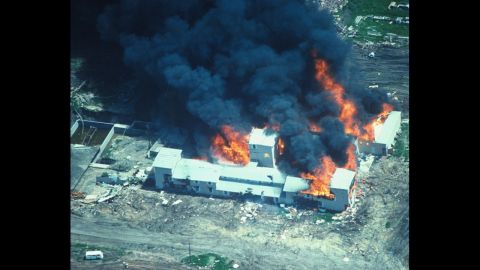 On February 28, 1993, agents of the Bureau of Alcohol, Tobacco, Firearms and Explosives tried to serve search and arrest warrants for allegedly illegal weapons at the Branch Davidian Christian compound near Waco, Texas. A gunbattle ensued followed by a seven-week standoff between church followers and FBI agents who had taken over the situation. Branch Davidian leader David Koresh refused to negotiate and when FBI forces moved in on April 19 with tear gas, a fire set the building ablaze. In total, 82 Branch Davidians, including 24 children, and four federal agents died. Above, the compound burns on April 19, 1993, after FBI agents moved in.