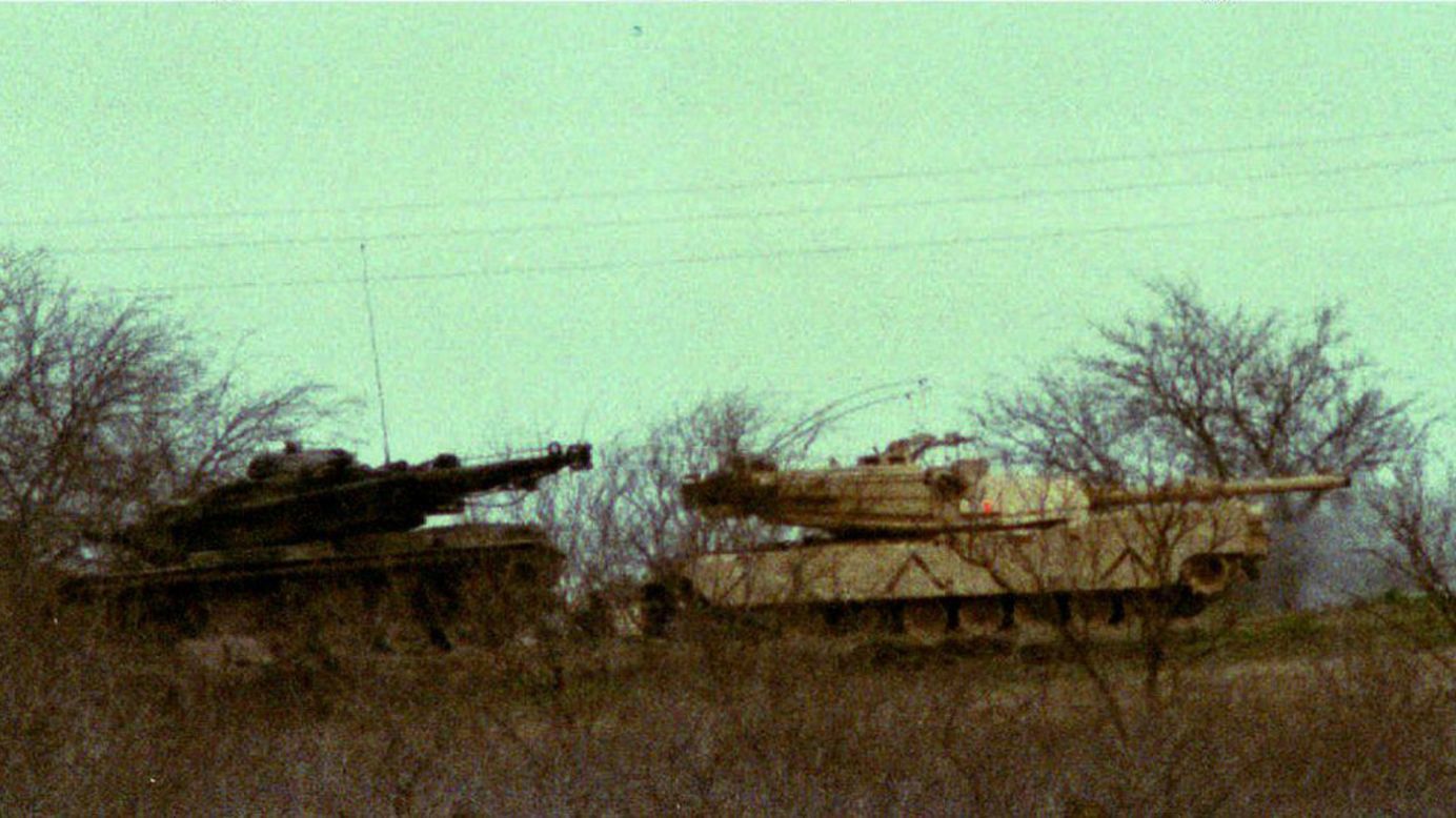 Two M1 Abrams tanks sit in the underbrush about 200 yards from the Branch Davidian compound on March 10, 1993.