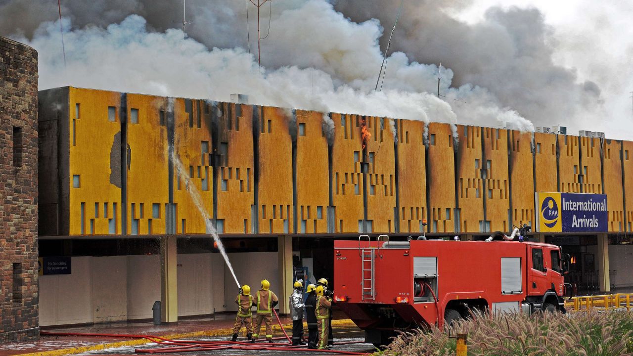 Firefighters try to control a blaze at the Jomo Kenyatta International Airport in Nairobi, Kenya, on Wednesday, August 7. Fire engulfed the airport's entire international terminal, but no casualties were reported. Domestic flights have resumed, and some international ones are set to begin again Thursday, August 8, a Kenyan official said. 