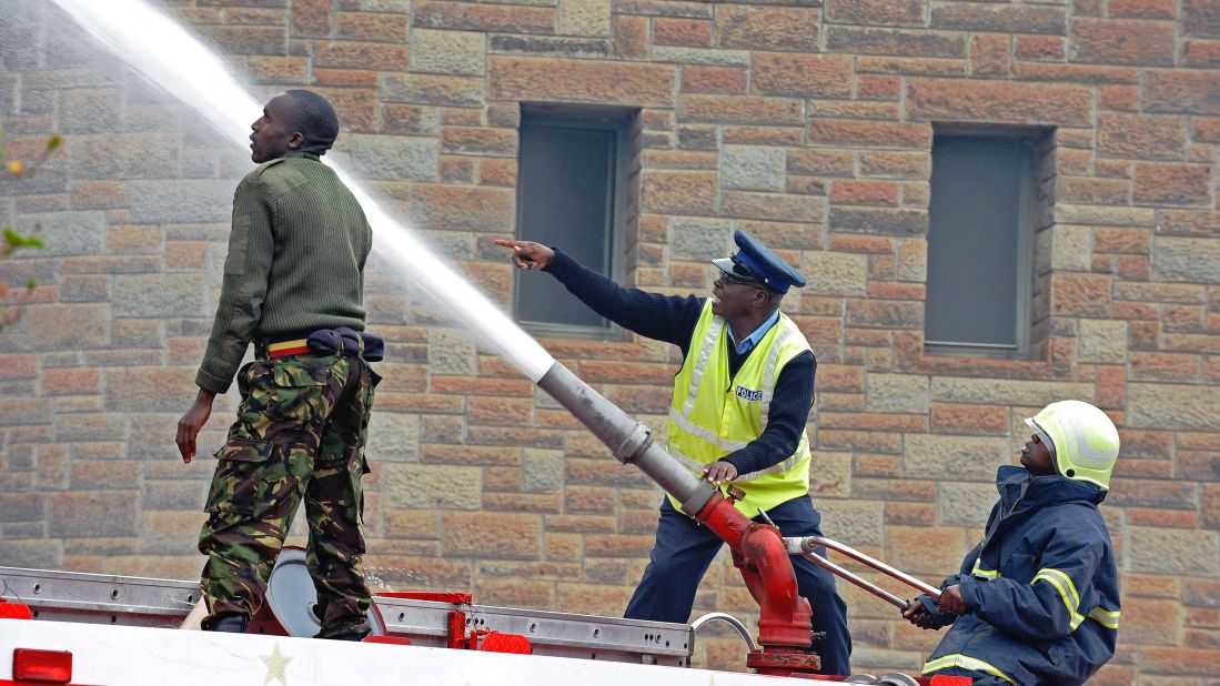 Firefighters shoot a water cannon on flames outside the Nairobi airport August 7.