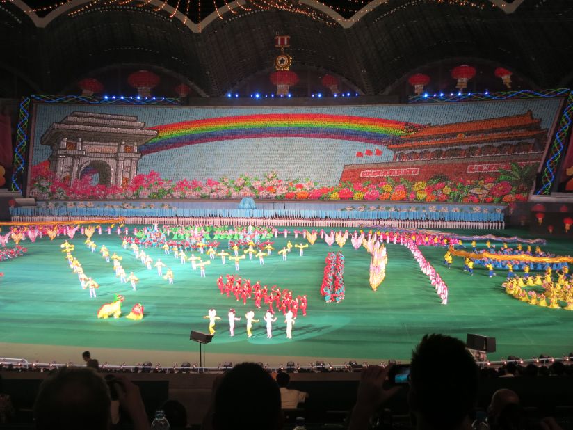 That rainbow-themed backdrop consists of thousands of people holding up different boards. This year they flashed messages of peace and friendship, as well as the rainbow between Pyongyang's Arch of Triumph and Beijing's Tiananmen Square Gate, while Lion Dancers, Pandas and Russian Dancers strutted about on stage. 