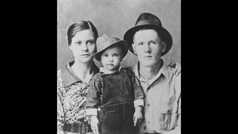 Elvis poses for a family portrait with his parents, Gladys Presley and Vernon Presley, in Tupelo, Mississippi, in 1937.