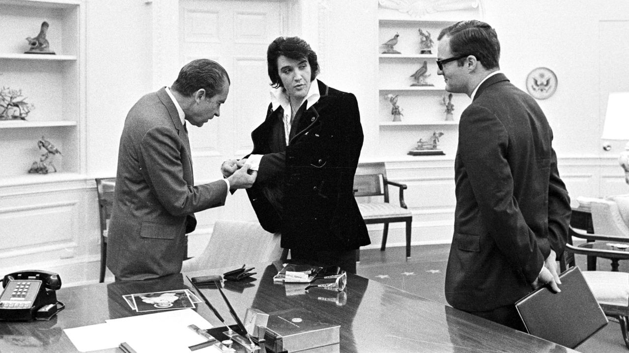 Elvis shows President Richard Nixon his cuff links at the White House on December 21, 1970.