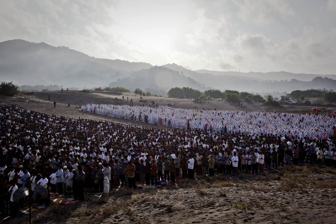 AUGUST 8 - YOGYAKARTA, INDONESIA : Indonesian Muslims perform <a href="http://cnn.com/2013/08/08/world/sweet-eid-break-fast-treats/index.html?hpt=hp_c5">Eid Al-Fitr</a> prayers on Parangkusumo beach on August 8. Eid Al-Fitr marks the end of Ramadan, the Islamic month of fasting, and begins after the sighting of a new crescent moon.