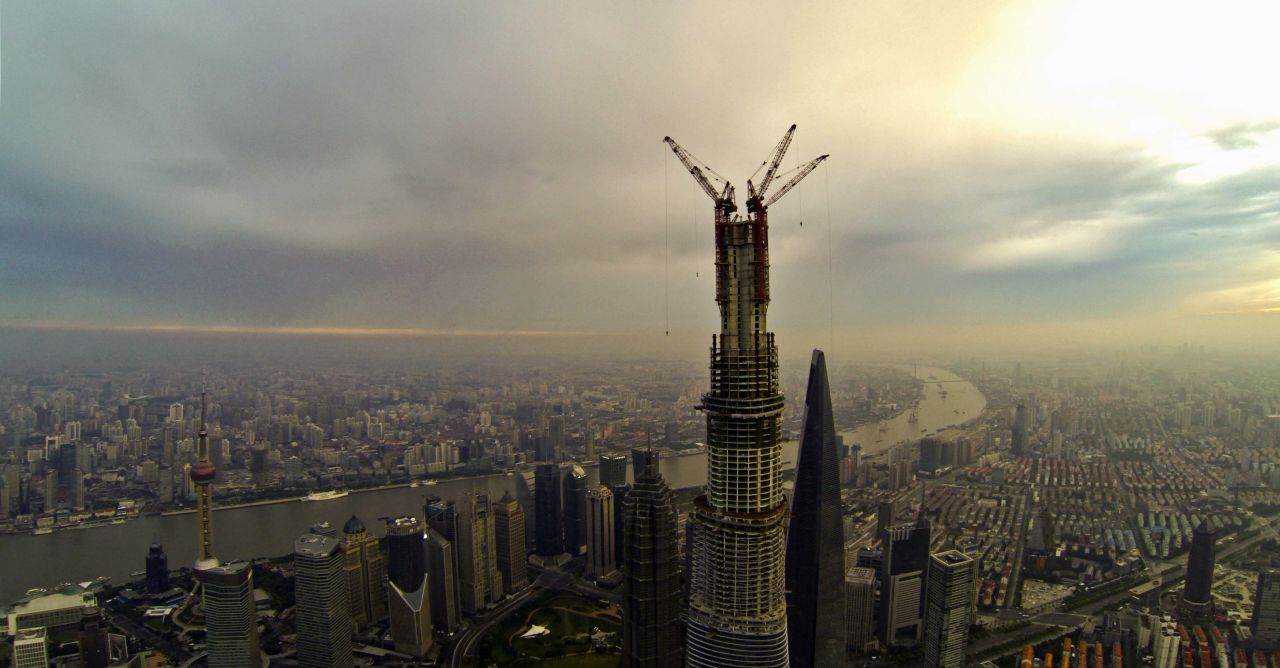 AUGUST 5 - SHANGHAI, CHINA: Work on the main structure of the Shanghai Tower was completed on August 3, when a crane placed a steel beam 580 meters above the ground. China's construction boom gives rise to some of the world's tallest buildings. <a href="http://cnn.com/2013/08/05/business/china-sky-city-skyscraper-index/index.html?hpt=ias_t5">But some say it can also bring economic bust.</a>