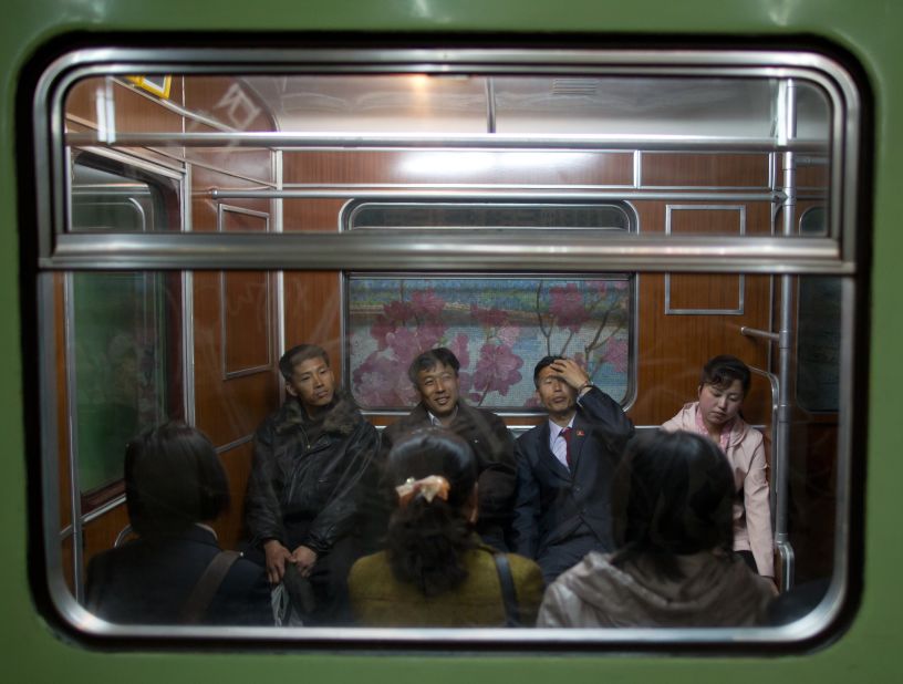 Commuters sit aboard a train at Puhung subway station in Pyongyang. The underground network has two lines and 17 stations. Inspired by the grand Moscow Metro, many of the stations have ornate chandeliers and paintings and murals on the walls. 