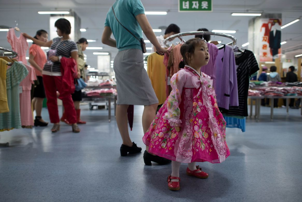 A North Korean girl wearing traditional dress stands at a clothing section inside a supermarket in Pyongyang. Officially, visitors aren't allowed in department stores, but this is a rule that is given flexibility. 