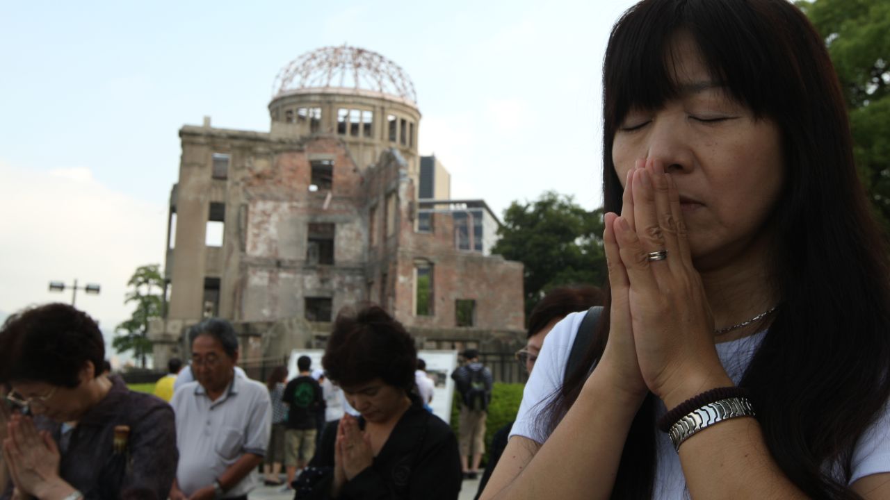 People pray in front of the Atomic Bomb Dome in Hiroshima on the 68th anniversary, August 6, of the day the atom bomb hit.  