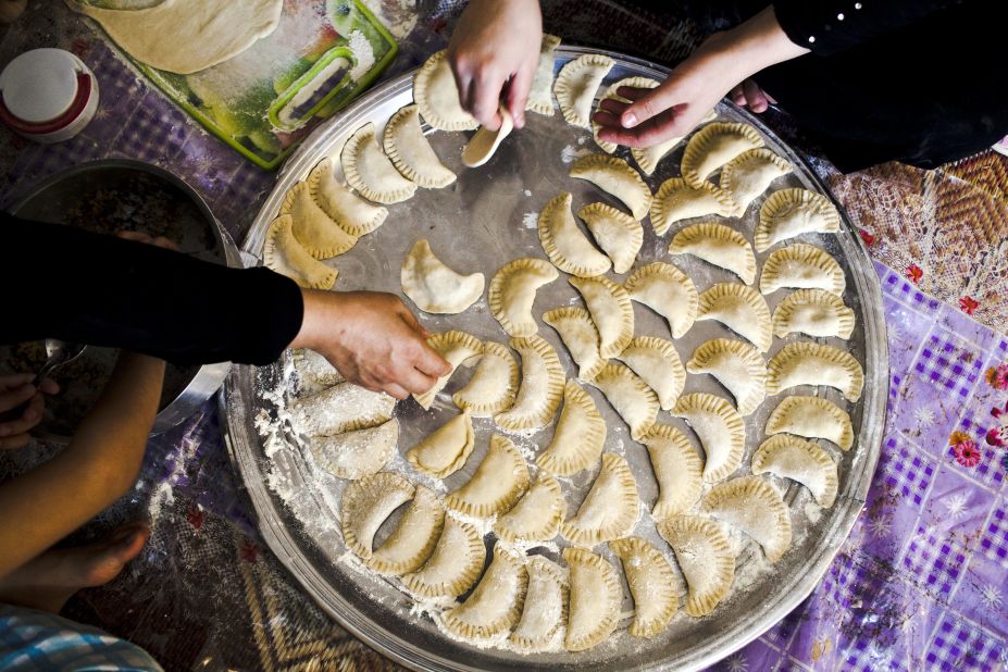Mahasen, 44, (left) helps her daughter Lina make sambousek -- small, meat-filled pastries -- for their iftar meal at their home in Cairo, Egypt. "Ramadan in Syria was always at our house, now we are displaced and we don't know when we can go back," said Mahasan. 