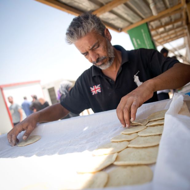 Yahya arranges his freshly made qatayef, sweet pancakes traditionally served during the Islamic fasting month of Ramadan. He was a baker in his native Syria and now puts his skills to use in Za'atari, Jordan. 
