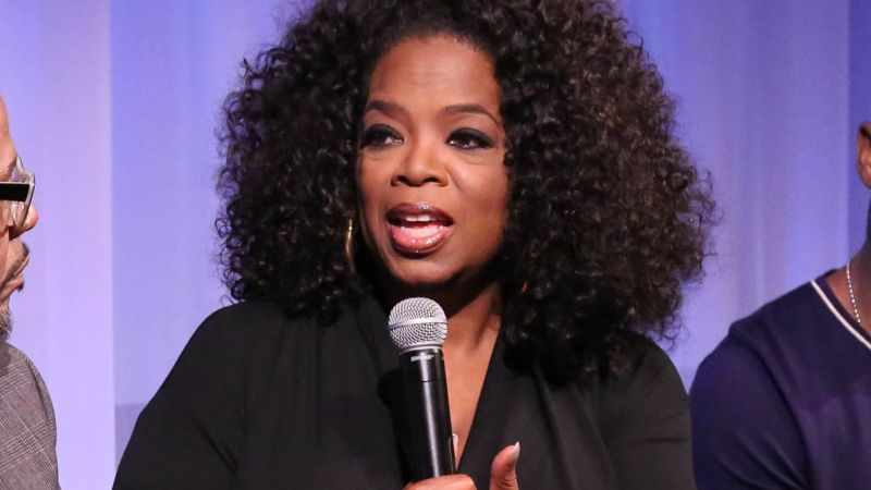 Oprah Winfrey shows off her slimmed down figure in a belted co-ord at the Louis  Vuitton show