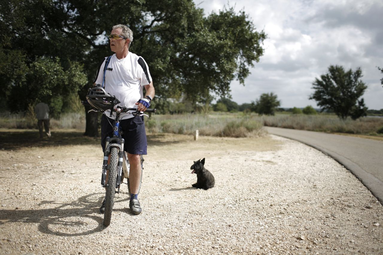 President George W. Bush rides a bicycle at his ranch in Crawford, Texas, in August 2007.