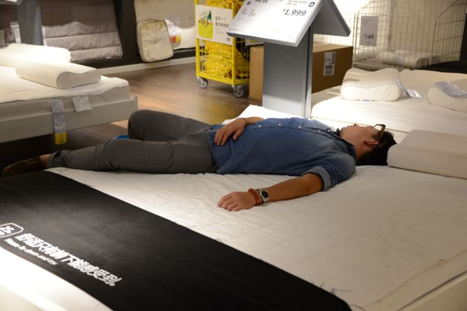 Ikea's latest mattress commercial? "You can only feel the comfort when you lie down," says the sign in Chinese. This "customer" needed no further invitation. 