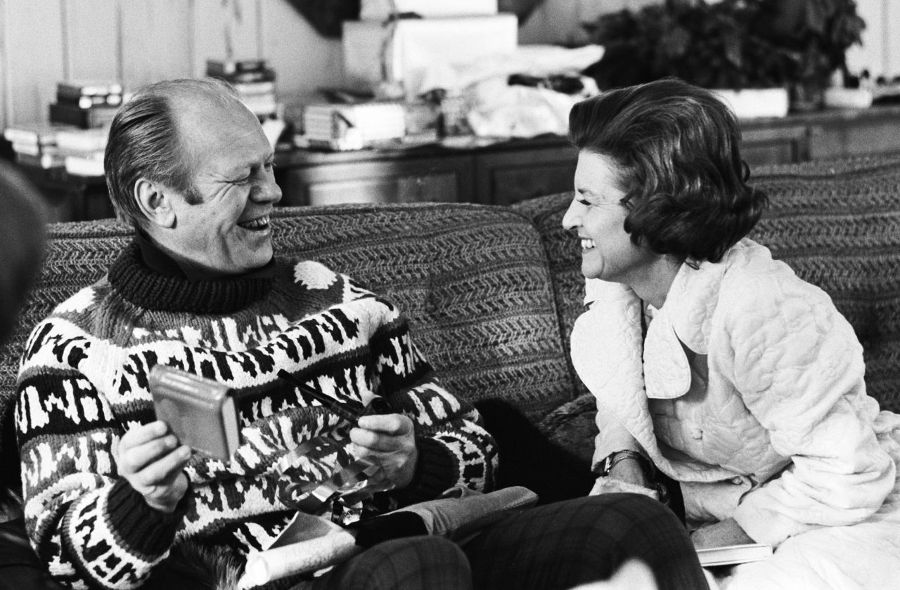 President Gerald Ford opens a gift from his wife, Betty, during their usual Christmas vacation spot in Vail, Colorado, in December 1974.