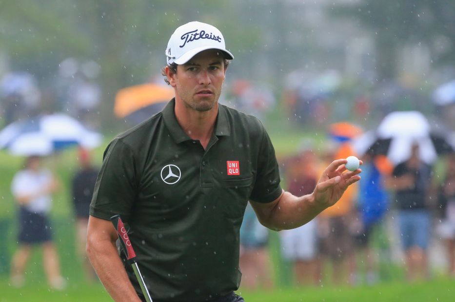 Adam Scott acknowledges the galleries on his way to a second round 68 at a rainy Oak Hill in the second round of the PGA Championship.  